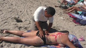 Busty Arab MILF massage at the beach